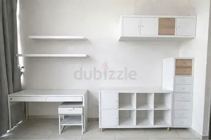 White modular storage wall set with desk, shelves and cabinets