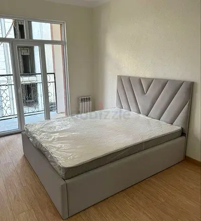 Light grey upholstered double bed