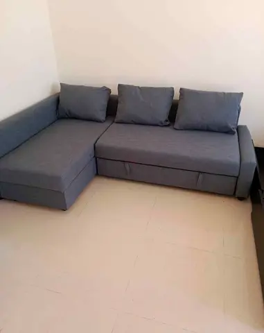 L-shaped grey fabric sofa bed with storage - good condition