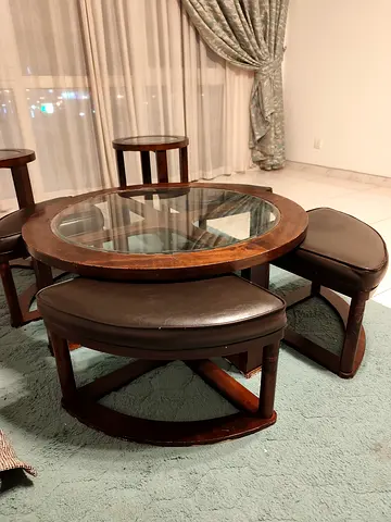 Round wooden coffee table with glass top and 4 matching stools