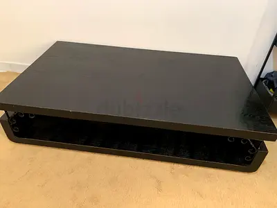 Low black wooden coffee table with open shelf