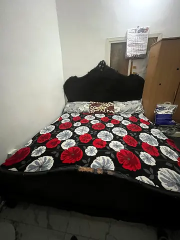 Used ornate black wooden double bed with carved headboard