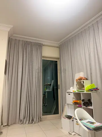 Elegant grey curtains layered with soft white sheer curtains