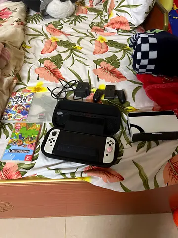 Nintendo Switch oled with three games and travel bag