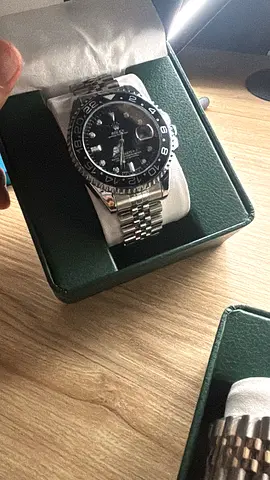 1:1   Rolex GMT-Master II with a black bezel and Jubilee bracelet.