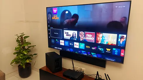 Hisense 65-inch Smart LED TV wall-mounted with Bose soundbar and subwoofer - Good condition