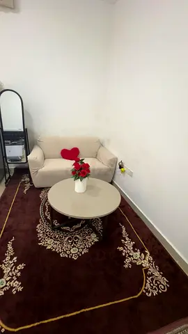 2-seater beige sofa with coffee table and brown rug and mirror