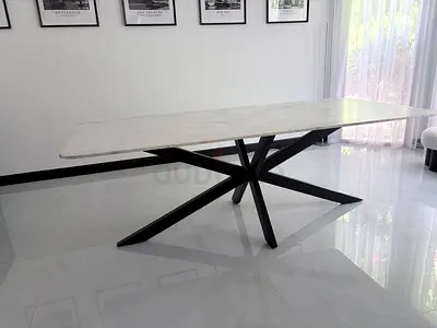 Modern beautiful marble-top dining table for 8 persons with black starburst base
