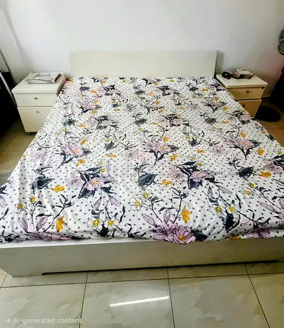 White IKEA bed frame with headboard and two bedside tables - good condition.