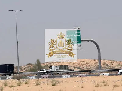 أرض تجارية 8,700 قدم على شارع مليحة مباشرة | تملك حر للعرب | أقساط