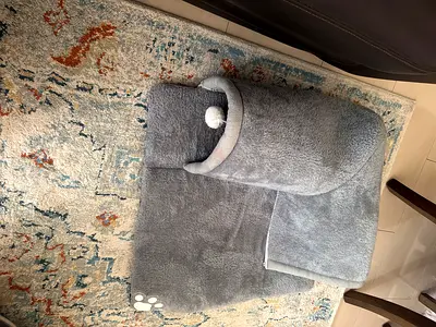 Soft grey plush cat bed with tunnel and pom-pom toy