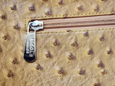 Light brown ostrich-effect shoulder bag with exterior zip pocket