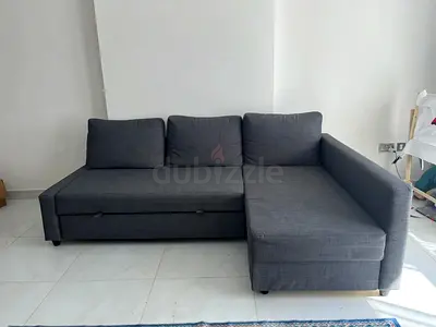 Grey L-shaped sofa bed with storage, good condition