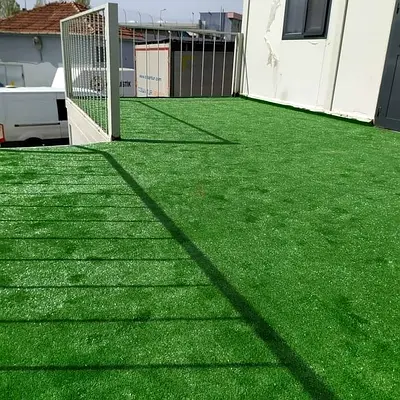 Outdoor artificial grass turf - green synthetic lawn (installed section)