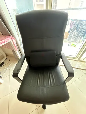 Black ergonomic office chair with headrest and lumbar support