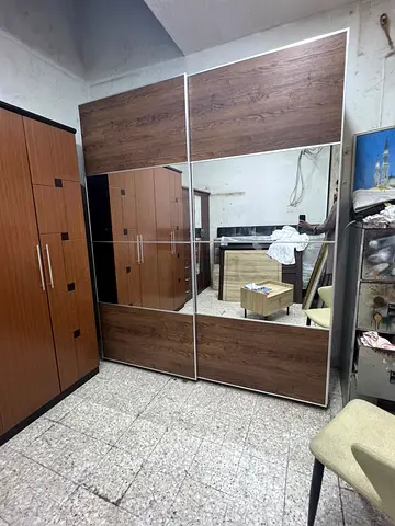 Large Sliding Wardrobe with Mirrored Panels and Wood Finish