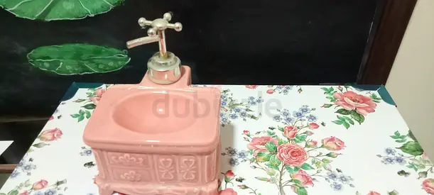 Vintage-style ceramic ornamental lotion dispenser with faucet like cover (ornamental)
