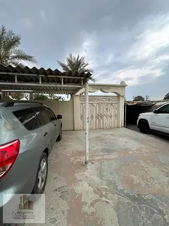 A big Arabic house for sale in Ras Al Khaimah, Al Kharran area, on a corner with two streets. The h