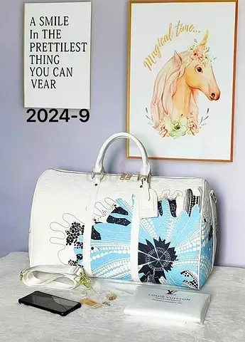 White patterned duffel bag with detachable strap