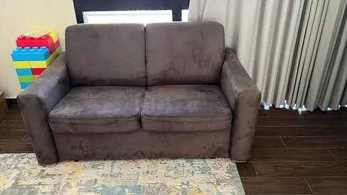 2-seater grey fabric sofa bed in good condition