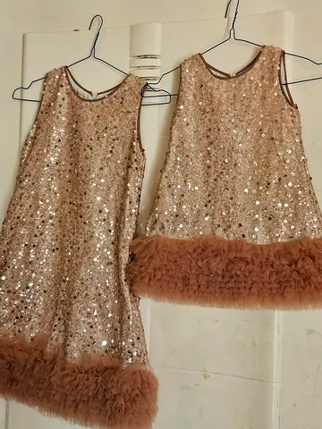 Pair of sequin party dresses with feather trim - size not specified