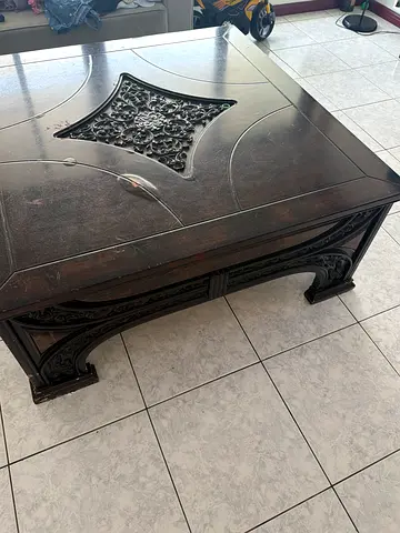 Solid carved dark wood coffee table with ornate inlay - used