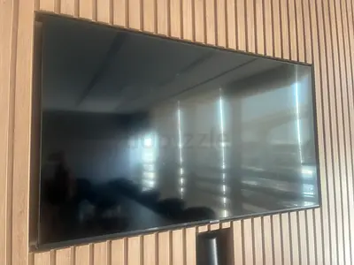 55-inch LED TV mounted, good working condition