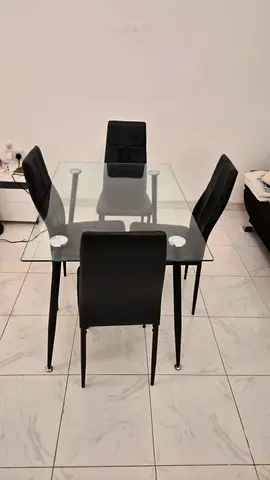 Glass Dining Table with 4 Black Chairs - Good Condition. 143cm x 83cm