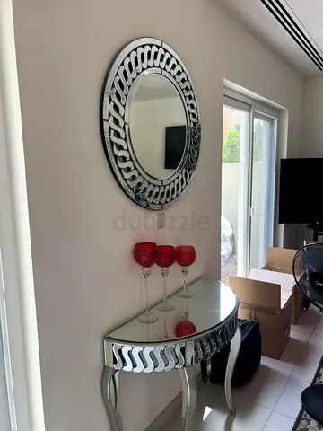 Decorative mirrored console table with matching round wall mirror