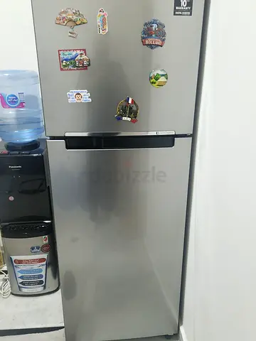 Single-door stainless steel refrigerator with water dispenser - good condition