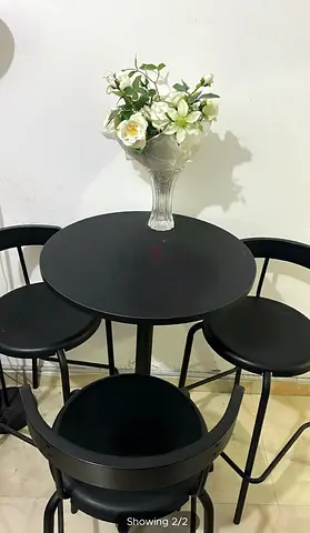 Black round bistro table with three matching stools - compact set