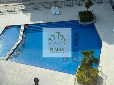 Sea-view 1-bedroom apartment for annual rent in Ajmal Makan City, Al Hamriya, with a master bedroom, American kitchen, balcony, gym, pool and beach ac