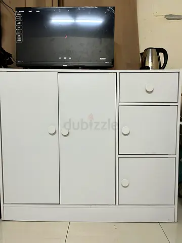 White wooden storage cabinet with drawers and cupboard - good condition