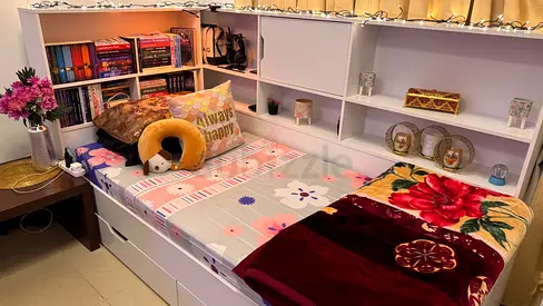 Single bed with built-in bookshelf headboard and under-bed drawers.