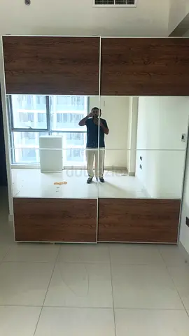 Large Sliding Wardrobe with Mirrored Panels and Wood Finish