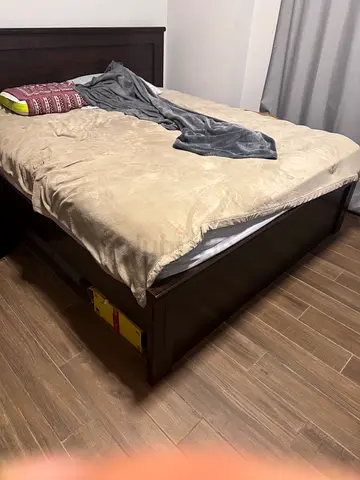 Dark wood double bed frame with headboard along with a good comfort mattress - good condition