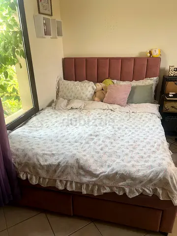 Upholstered Queen-size bed frame with padded headboard and storage space- dusty rose color