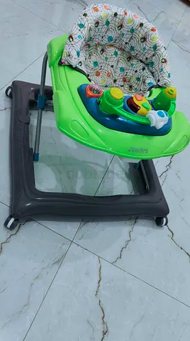 Brand new condition baby walker with padded seat and removable tray and toys - good condition
