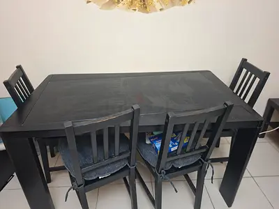 Solid black wooden dining table with 4 chairs - good condition