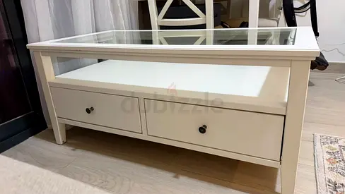 White wooden coffee table with glass top and storage drawers