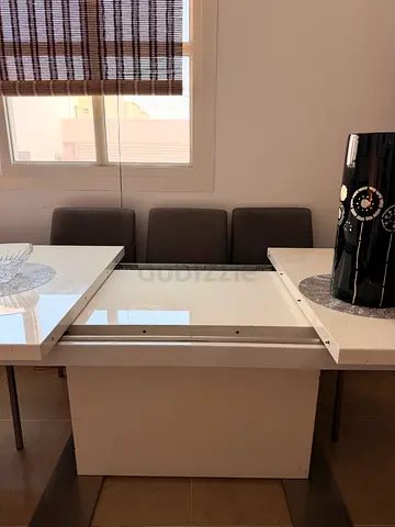 White extendable dining table with grey padded chairs - good condition from ID design 7k original pr