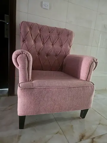 Single pink upholstered armchair with tufted back - good condition