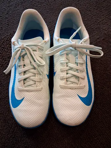 White Nike trainers with blue swoosh - size not specified, gently used