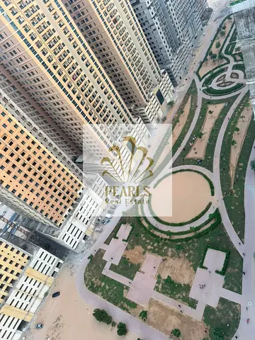 A 1-bedroom apartment with a living room is available for annual rent in Emirates City, Ajman. The apartment features a master bedroom, an open kitche