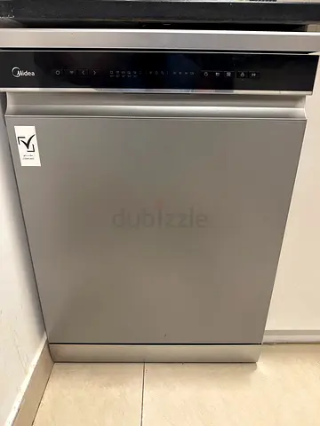 Silver freestanding dishwasher in excellent working condition with 3 years of extended warranty