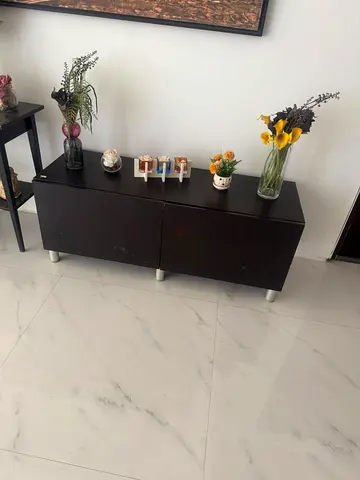 Low dark wood TV cabinet / storage unit with doors