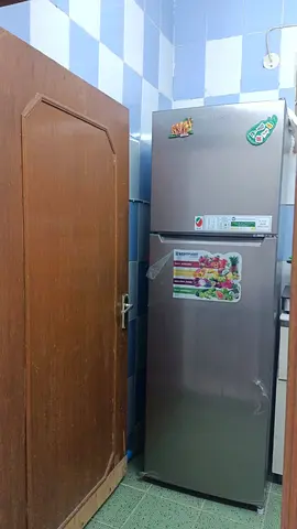 Silver double-door refrigerator in good working condition