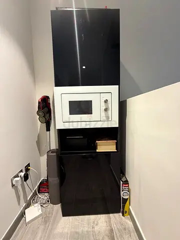 Tall glossy black kitchen cabinet