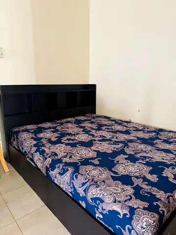 Dark wood queen bed frame with built-in headboard shelves