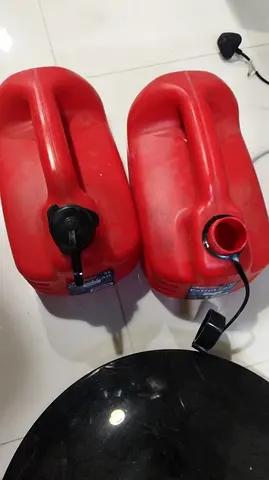 Pair of red plastic fuel/gas jerry cans (approx. 2 pcs) - used